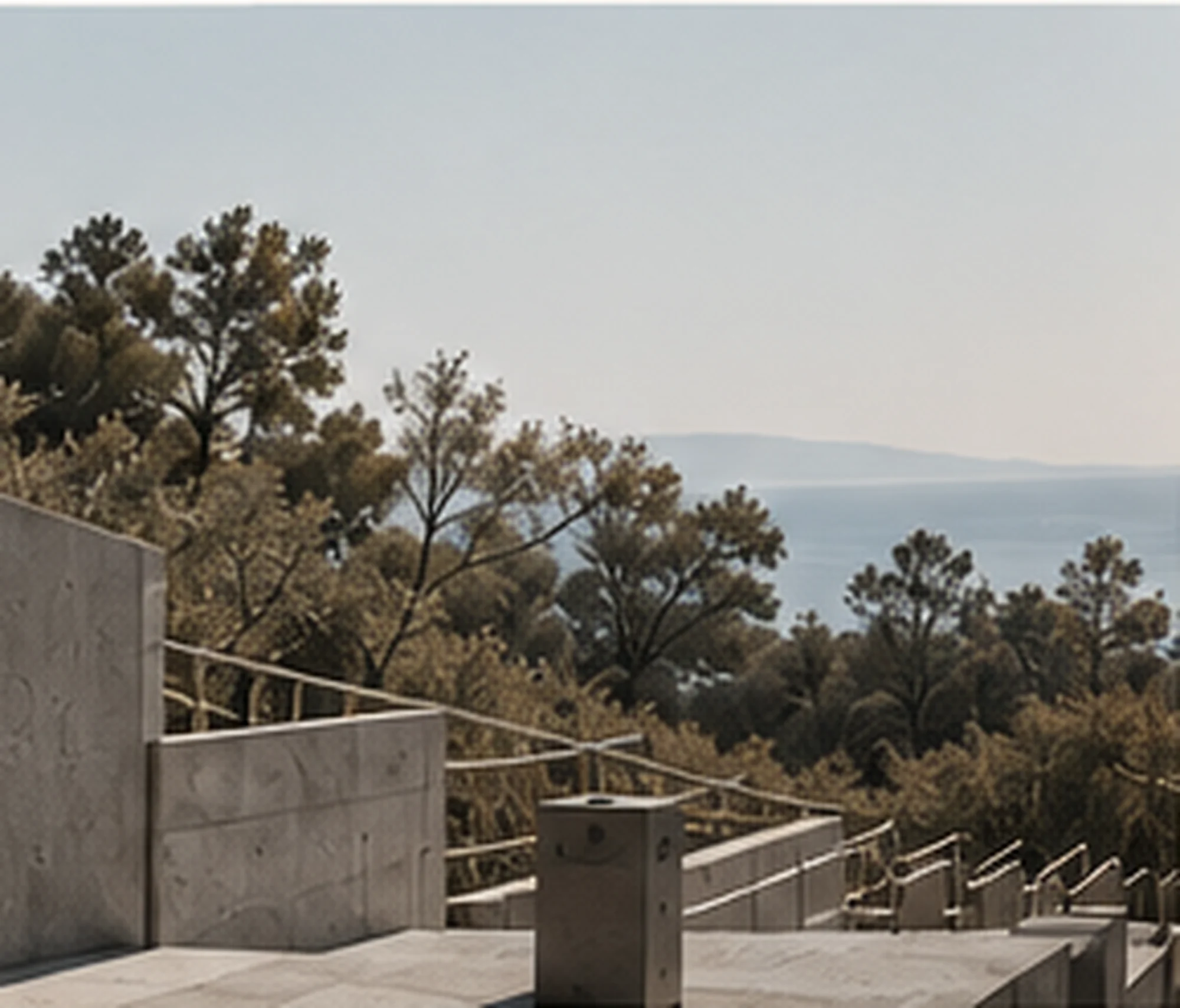 Concrete terraces opening onto a wooded coastal landscape